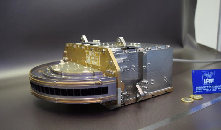 The JNA instrument with coins for scale The JNA instrument with coins for scale