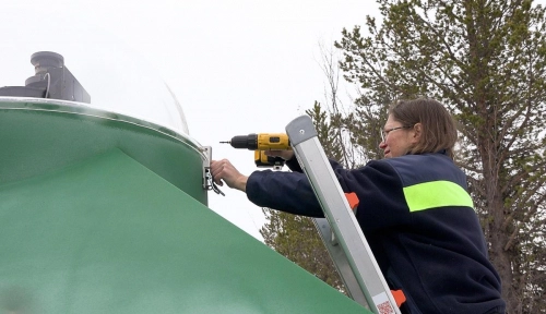 Engineer Daria Mikhaylova removes the protective dome
