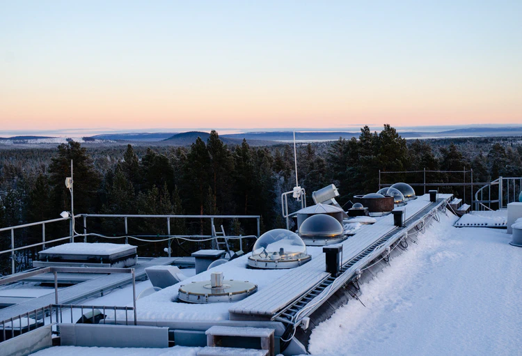 Snow-covered observatory roof with heated cupolas keeping the snow away