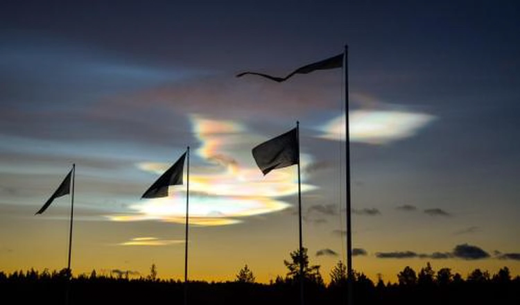 Mother of pearl clouds above flags