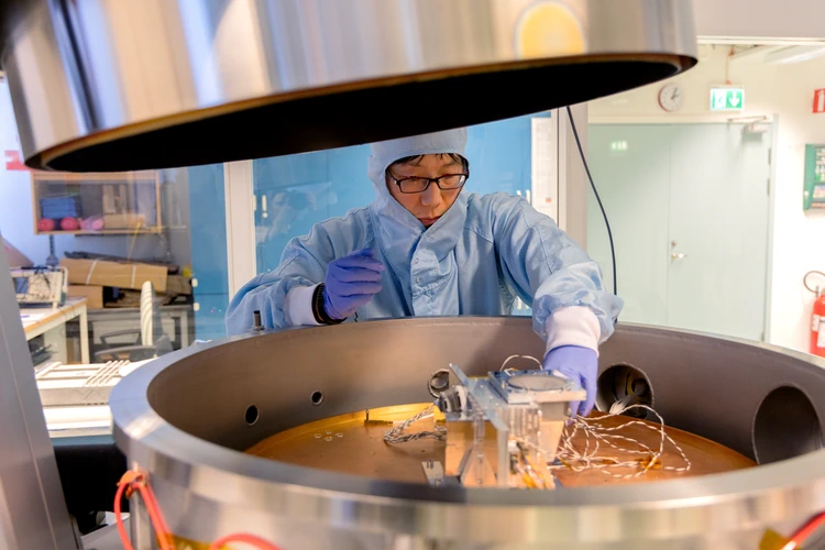 Scientist removing Sciena from test chamber